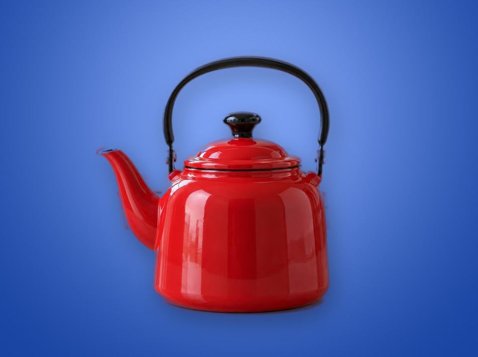 After: Glossy red enamel teapot on a kitchen counter — new background colour