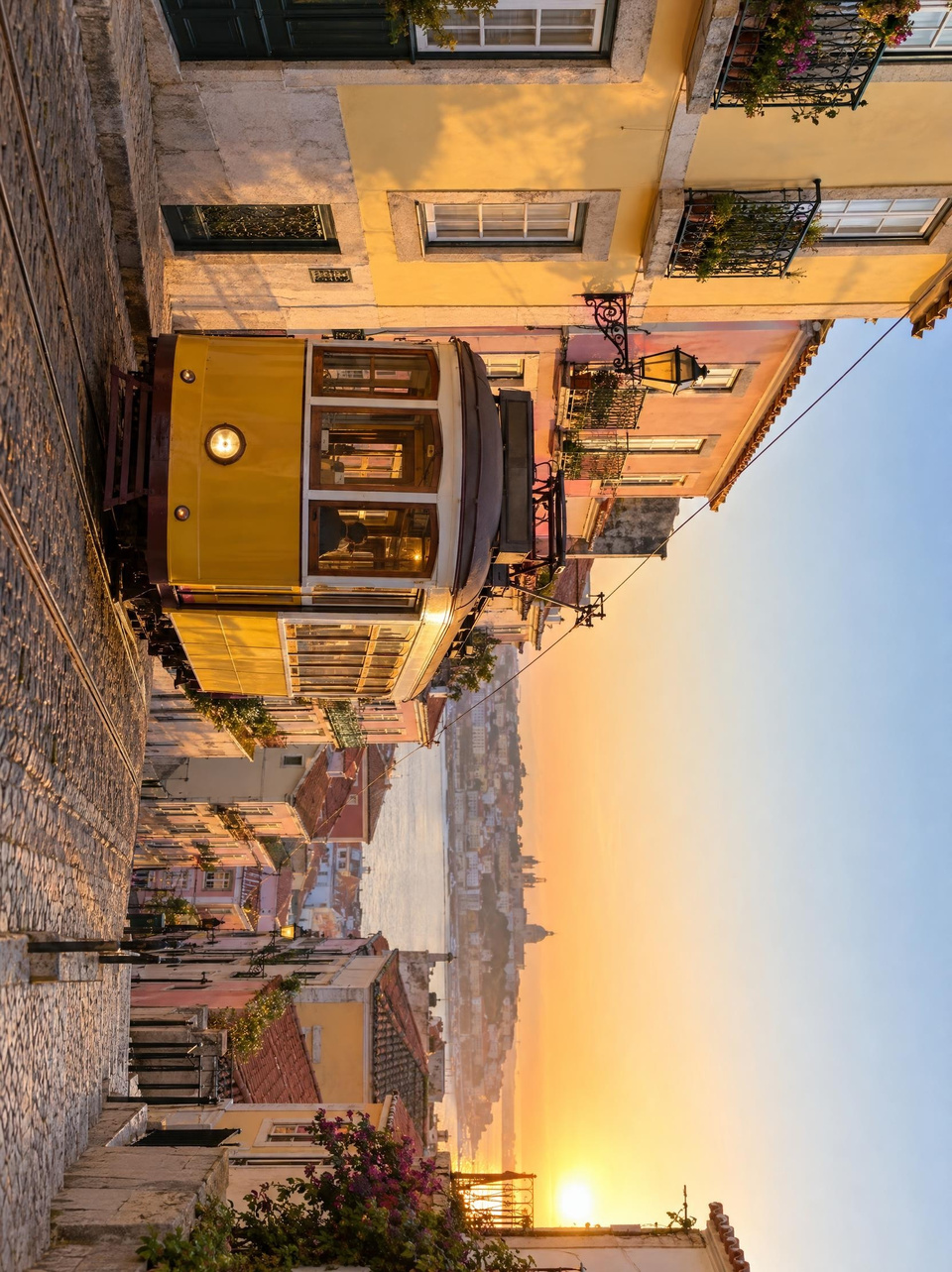 After: Yellow tram climbing a steep old-town street at golden hour — rotated