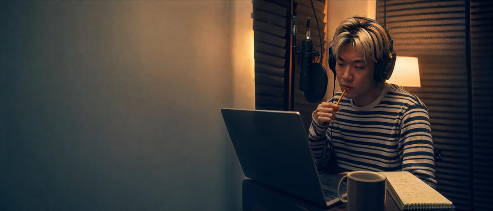 A songwriter in a vocal booth reworking one part of his chorus