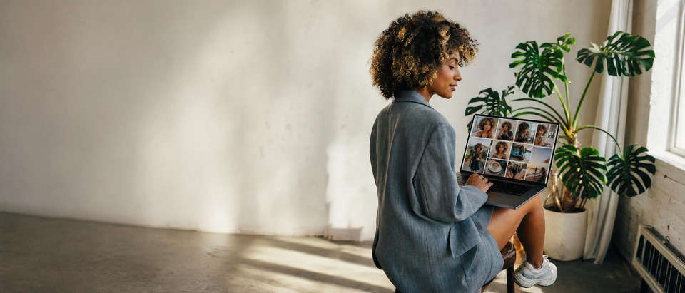 A creator looking at a grid of photos of herself in many different settings