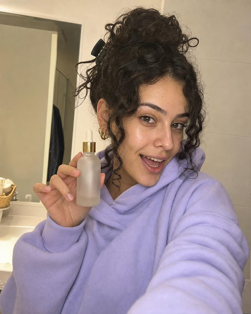 Output: A young creator showing the same serum to her phone camera, made from the product photo