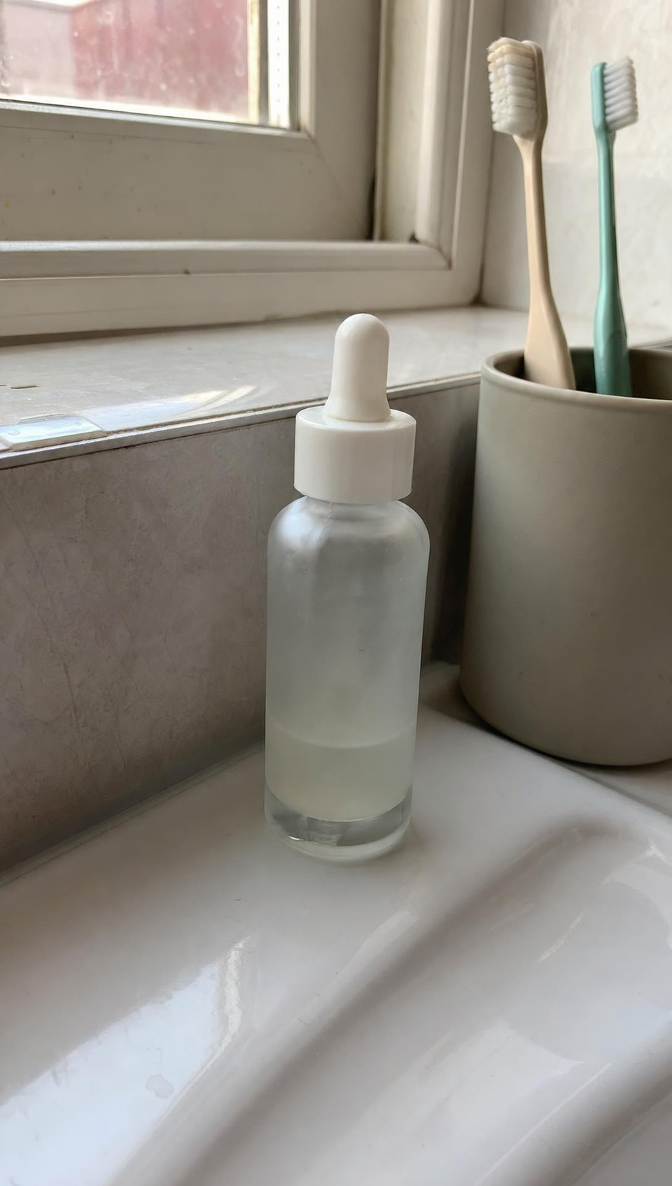 Input: A creator films herself in her bathroom talking about the serum, made from the product photo
